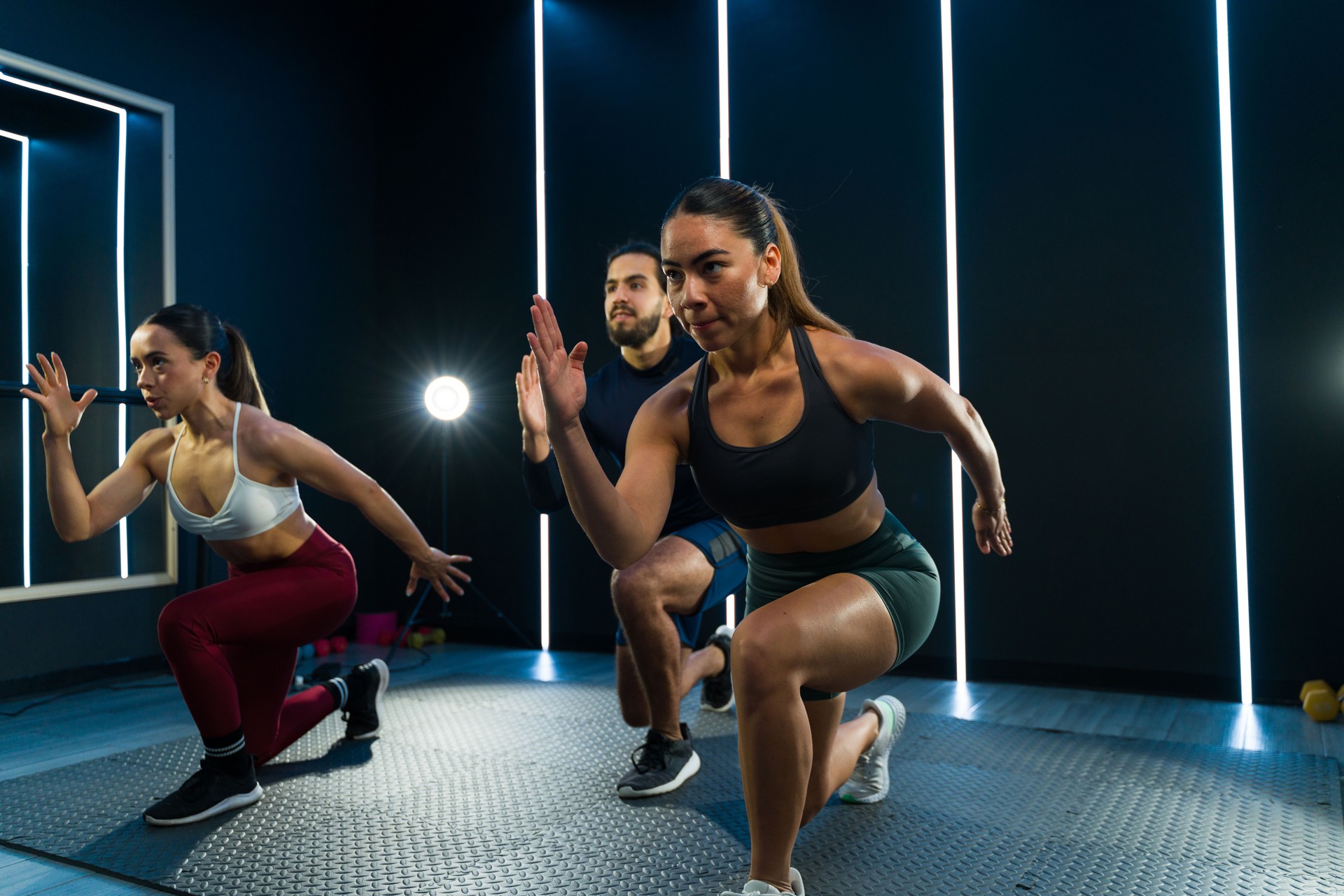 Energized fitness class with three Latin athletes in action